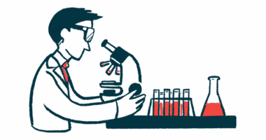 A scientist looks into a microscope.