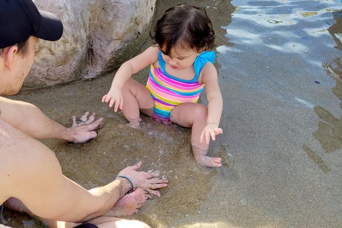 water therapy | AADC News | Richard and Rylae-Ann work on sensory play in the sand on the beach.