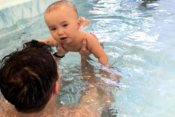 water therapy | AADC News | Richard holds Rylae-Ann in the pool to provide physical therapy support.