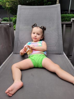 hip surgery | AADC News| Rylae-Ann relaxes on a lounge chair after pediatric hip surgery. Her right leg is slightly bent, while her left leg, which was operated on, is sticking out straight.