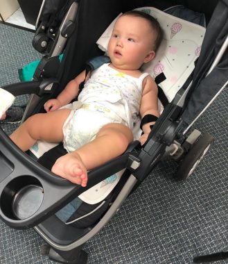 excessive sweating | AADC News | Rylae-Ann reclines on a cooling pad while out and about in her stroller.