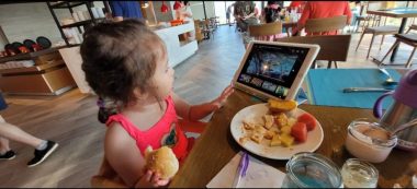 | AADC News | Rylae-Ann watches and iPad while eating a meal.