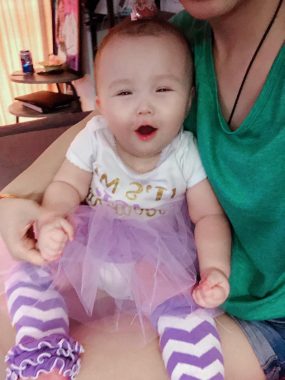 AADC deficiency diagnosis | AADC News | Rylae-Ann smiles while on her mother's lap.