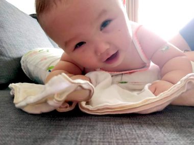 massage for children | AADC News | Rylae-Ann, pictured as a baby, lies on her stomach on a burpee as her parents massage her back.