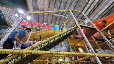 indoor playgrounds | AADC News | Rylae-Ann and her mother climb up an incline at an indoor playground