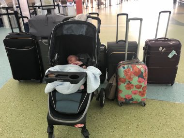 children with special needs | AADC News | photo of Rylae-Ann, in a stroller, with many large suitcases behind her