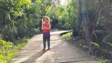 aadc deficiency | AADC News | Rylae-Ann stands on a wooden platform trail through the Florida forest on a hot, sunny day