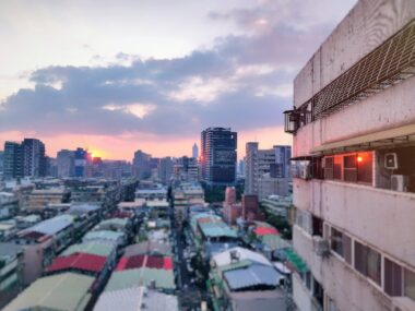 A photo captures a view of the sunset over Taipei, Taiwan, from an Airbnb apartment.