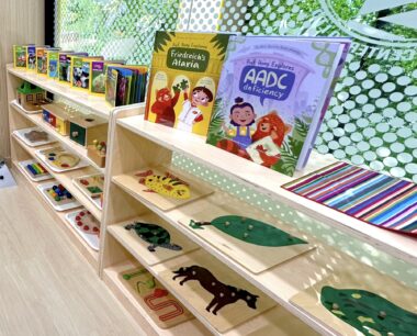 A story-style low bookshelf displays children's books and games.