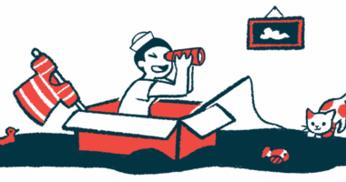 A child wearing a sailor hat looks through a telescope while sitting in a cardboard box.