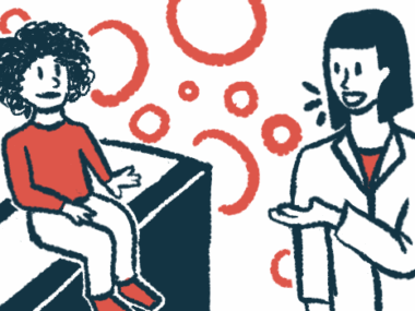 A doctor speaks to a child siting on an examination table.